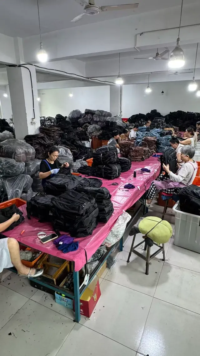 QC inspector checking a finished backpack