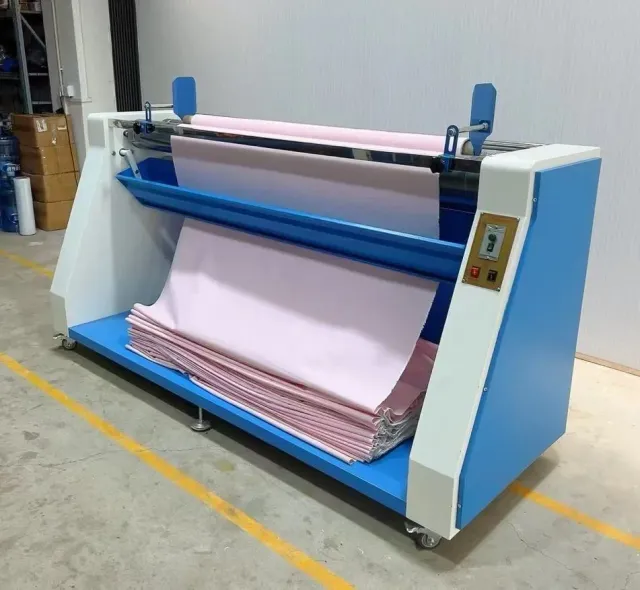 Fabric inspection machine checking a dyed roll for defects and shade